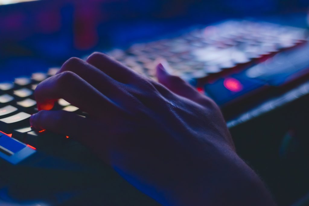 LearnOnline International A level Computer Science - hand on lit up keyboard