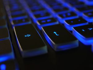 LearnOnline Fast Track Computer Science A level Self-study Close up of computer keyboard with blue lighting