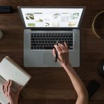 What is LearnOnline Live? Open laptop with hand holding pen whilst typing