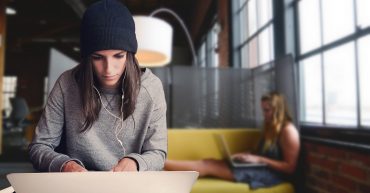 Fast Track A levels. 18-20 year old sat at laptop with someone in the background also on laptop