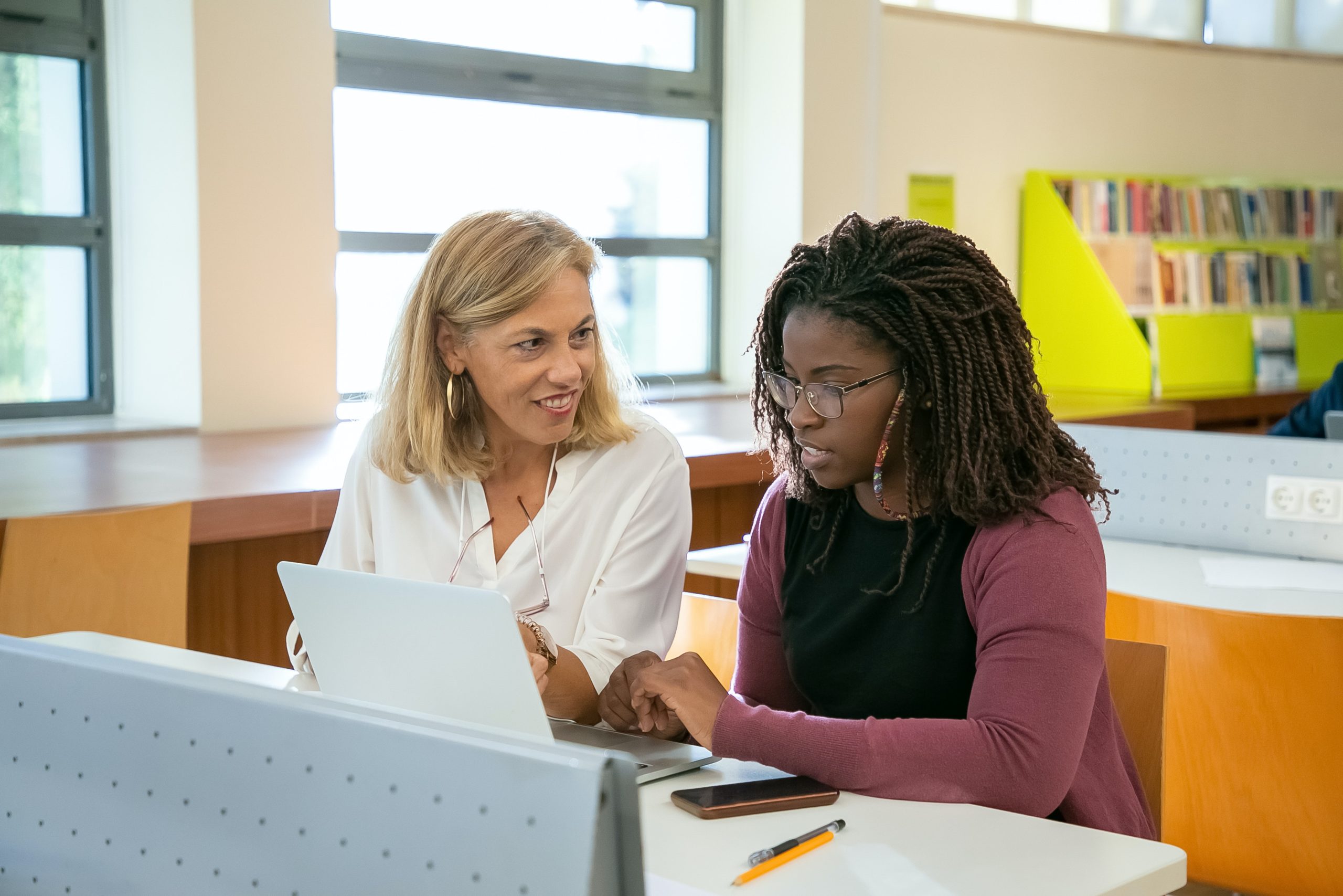 LearnOnline Home Education - two women at a desk talking