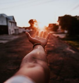 LearnOnline Extension Fees Hand reaching out toward the setting sun