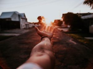 LearnOnline Extension Fees Hand reaching out toward the setting sun