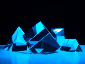 LearnOnline Mathematics Higher IGCSE Artistic image of cube and triangular shaped prisms