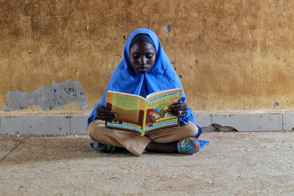 International Day of Education 2023 Girl reading maths book