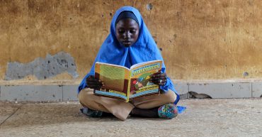 International Day of Education 2023 Girl reading maths book