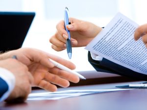 LearnOnline Fast Track Business A level Self-study Two people with pens and documents