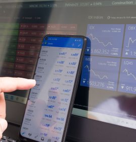 LearnOnline Fast Track Economics A level Self-study Computer & mobile screen with stocks information