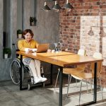 What is LearnOnline? 16-20 year old sat at desk in wheelchair with laptop and coffee