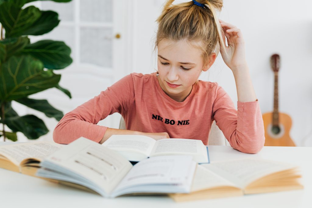 LearnOnline Essential Three IGCSE Package. 14-16 year old girl reading textbook