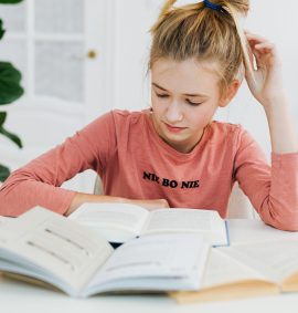 LearnOnline Essential Three IGCSE Package. 14-16 year old girl reading textbook