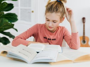 LearnOnline Essential Three IGCSE Package. 14-16 year old girl reading textbook