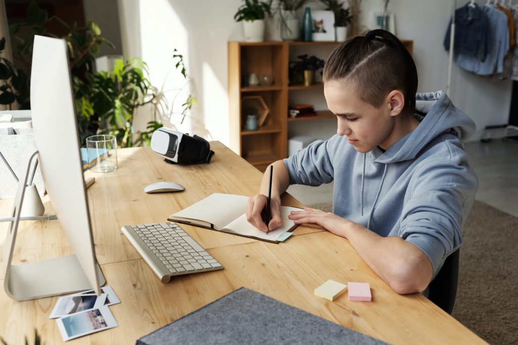 What is supported self-study? News article image 14-16 year old sat at desk writing in notebook in front of computer