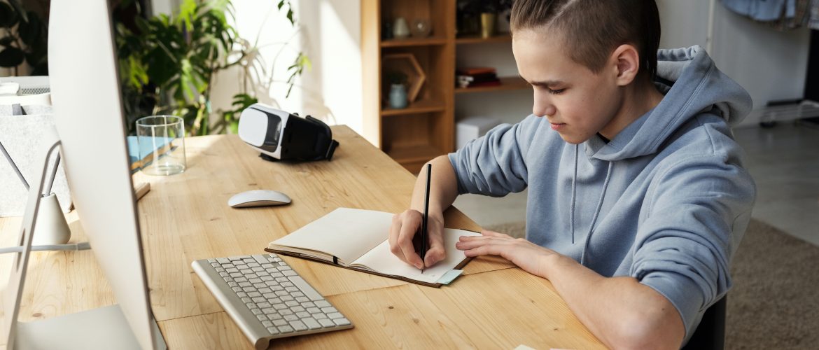 What is supported self-study? News article image 14-16 year old sat at desk writing in notebook in front of computer