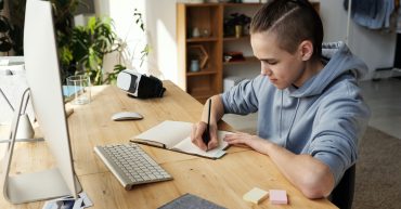 What is supported self-study? News article image 14-16 year old sat at desk writing in notebook in front of computer