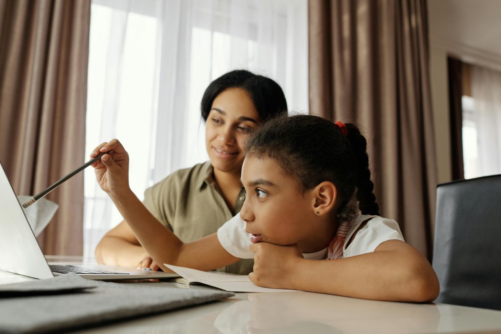 LearnOnline Science IGCSE Package. Mother and daughter reading something on computer